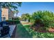 Spacious backyard features a stone patio with seating, lush lawn, and privacy landscaping at 5910 Caldera Ridge Dr, Lithia, FL 33547