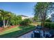 Private backyard with lush landscaping, a fire pit, and a seating area for outdoor gatherings at 5910 Caldera Ridge Dr, Lithia, FL 33547