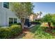 Lush backyard with green lawn, a patio seating area, palm trees, and well-maintained landscaping at 5910 Caldera Ridge Dr, Lithia, FL 33547
