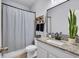 Bathroom with granite countertops, a large mirror, and a shower with a curtain at 5910 Caldera Ridge Dr, Lithia, FL 33547