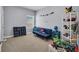 Bright bedroom with a blue futon, gray walls, and shelves full of toys at 5910 Caldera Ridge Dr, Lithia, FL 33547
