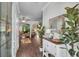 Elegant foyer featuring hardwood floors, decorative mirror, stylish console table, and a glimpse into the living spaces at 5910 Caldera Ridge Dr, Lithia, FL 33547