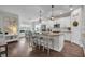 Open kitchen with granite countertops, white cabinets, stainless appliances, and a dining area with seating for six at 5910 Caldera Ridge Dr, Lithia, FL 33547