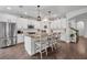 Bright kitchen with granite counters, stainless appliances, white cabinetry, and seating at the center island at 5910 Caldera Ridge Dr, Lithia, FL 33547