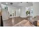 Expansive living room featuring a staircase, hardwood floors, and comfortable seating at 5910 Caldera Ridge Dr, Lithia, FL 33547