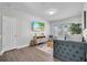 Cozy living room with natural light, a mounted TV, and a comfortable sofa at 5910 Caldera Ridge Dr, Lithia, FL 33547