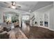 Open-concept living room with hardwood floors, staircase, and access to other living spaces at 5910 Caldera Ridge Dr, Lithia, FL 33547