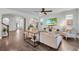 Bright living room features hardwood floors, a large TV, modern furniture, and an open floor plan with archways at 5910 Caldera Ridge Dr, Lithia, FL 33547