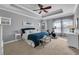 Main bedroom with carpet floors, tray ceiling, ceiling fan, walk-in closet, and lots of natural light at 5910 Caldera Ridge Dr, Lithia, FL 33547