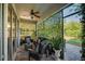 Cozy covered patio featuring comfortable seating, privacy lattice, and a ceiling fan at 5910 Caldera Ridge Dr, Lithia, FL 33547