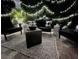Relaxing patio area with comfortable seating and ambient string lights for evening enjoyment at 5910 Caldera Ridge Dr, Lithia, FL 33547