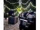 Inviting patio with string lights, black furniture, and a stylish outdoor rug at 5910 Caldera Ridge Dr, Lithia, FL 33547