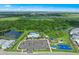 Aerial view of community amenities: a pool, playground, basketball court, and ample parking at 5953 Bluestar Ct, Lakewood Ranch, FL 34211