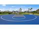 Bright blue community basketball court surrounded by manicured landscaping and palm trees under a clear blue sky at 5953 Bluestar Ct, Lakewood Ranch, FL 34211