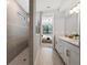 Modern bathroom featuring a glass shower, neutral decor and tile, double vanity and bright natural light at 5953 Bluestar Ct, Lakewood Ranch, FL 34211