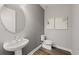 Bathroom with round mirror, sleek sink, and a modern toilet at 5953 Bluestar Ct, Lakewood Ranch, FL 34211