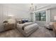 Bright bedroom featuring neutral décor, a plush carpet, and a large window offering scenic views at 5953 Bluestar Ct, Lakewood Ranch, FL 34211