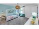 Charming bedroom featuring aqua accents, a white bed frame, and decorative 'hello' signage at 5953 Bluestar Ct, Lakewood Ranch, FL 34211