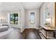 An inviting entryway with light gray paint, hardwood floors, a front door with sidelight, and a stylish console table at 5953 Bluestar Ct, Lakewood Ranch, FL 34211