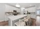 Bright kitchen featuring white cabinets, stainless steel appliances, a large island, and modern pendant lighting at 5953 Bluestar Ct, Lakewood Ranch, FL 34211