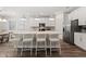 Bright kitchen featuring white cabinets, stainless steel appliances, a large island, and modern pendant lighting at 5953 Bluestar Ct, Lakewood Ranch, FL 34211
