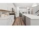 Spacious kitchen with white cabinets, stainless steel appliances, quartz countertops, and an island with seating at 5953 Bluestar Ct, Lakewood Ranch, FL 34211