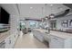 Kitchenette features modern stainless steel appliances, white cabinetry, and a serving bar at 5953 Bluestar Ct, Lakewood Ranch, FL 34211