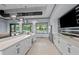 Kitchenette features modern stainless steel appliances, white cabinetry, and a serving bar at 5953 Bluestar Ct, Lakewood Ranch, FL 34211