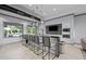 Modern kitchenette boasts sleek counters, stainless appliances, and bar seating with a pool view at 5953 Bluestar Ct, Lakewood Ranch, FL 34211