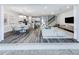 Open-concept living space with hardwood floors, seamlessly combining the living room, dining area, and kitchen at 5953 Bluestar Ct, Lakewood Ranch, FL 34211