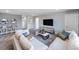 Living room features gray walls, white couches, a flat screen television, and soft carpet at 5953 Bluestar Ct, Lakewood Ranch, FL 34211