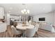 A kitchen that opens to the living room and dining area with stainless appliances and hardwood flooring at 5953 Bluestar Ct, Lakewood Ranch, FL 34211