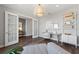 Well-lit home office with stylish French doors, hardwood floors, and a modern desk setup for a productive workspace at 5953 Bluestar Ct, Lakewood Ranch, FL 34211