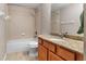 Well-lit bathroom featuring a bathtub, shower, toilet, and vanity with granite countertops at 6407 E 112Th Ave, Temple Terrace, FL 33617