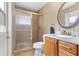 Bathroom features a walk-in shower, tiled walls, and a custom vanity at 6407 E 112Th Ave, Temple Terrace, FL 33617