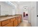 Bathroom with a double vanity and granite countertops leading to an office space at 6407 E 112Th Ave, Temple Terrace, FL 33617