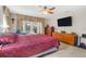 Bedroom featuring a ceiling fan, flat screen tv, and access to the back porch at 6407 E 112Th Ave, Temple Terrace, FL 33617