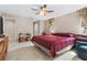 Spacious bedroom with a ceiling fan and a view of the backyard at 6407 E 112Th Ave, Temple Terrace, FL 33617