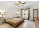 Bright bedroom featuring a bed frame and two side tables and a window at 6407 E 112Th Ave, Temple Terrace, FL 33617