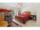 Bright bedroom featuring a wooden bed frame, ceiling fan, and window, with boxes needing to be unpacked at 6407 E 112Th Ave, Temple Terrace, FL 33617