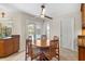 Bright breakfast nook features an elegant ceiling fan and French doors that open to a screened pool at 6407 E 112Th Ave, Temple Terrace, FL 33617