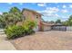Home featuring a spacious brick driveway with a 2-car garage and verdant landscaping at 6407 E 112Th Ave, Temple Terrace, FL 33617