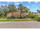 Home with a 2-car garage, featuring an additional upstairs window and lush landscaping at 6407 E 112Th Ave, Temple Terrace, FL 33617
