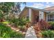 Inviting front entrance featuring lush landscaping and a stone pathway leading to the front door at 6407 E 112Th Ave, Temple Terrace, FL 33617
