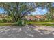 Well-maintained one-story home featuring a lush front lawn and mature trees at 6407 E 112Th Ave, Temple Terrace, FL 33617