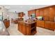 Stylish kitchen featuring ample counter space, custom cabinets, and an island at 6407 E 112Th Ave, Temple Terrace, FL 33617