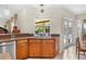 Kitchen featuring custom wood cabinets, a granite countertop, and a sink overlooking the pool at 6407 E 112Th Ave, Temple Terrace, FL 33617