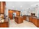 Well-lit kitchen with an island, stainless steel appliances and custom wood cabinetry at 6407 E 112Th Ave, Temple Terrace, FL 33617