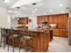 Well-appointed kitchen featuring granite countertops, wooden cabinets, and pendant lighting at 6407 E 112Th Ave, Temple Terrace, FL 33617