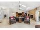 Open-concept living room with stone fireplace, vaulted ceiling, and skylights at 6407 E 112Th Ave, Temple Terrace, FL 33617